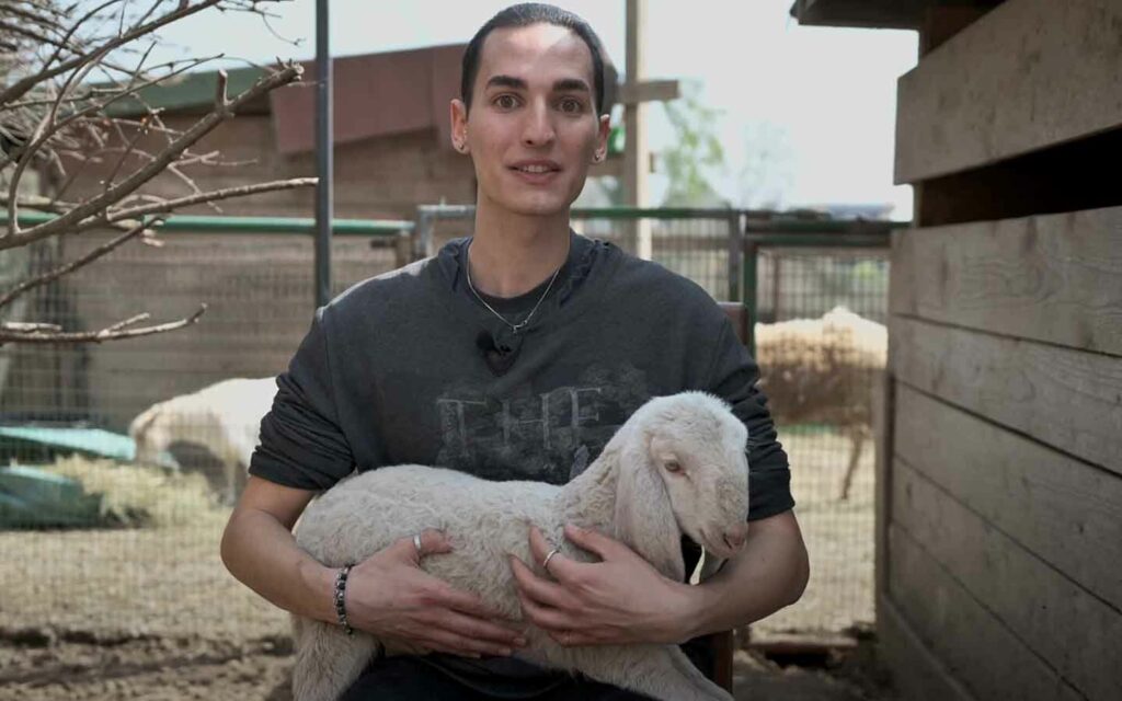 Andrea Capodanno at animal sanctuary promoting a plant-based diet. 