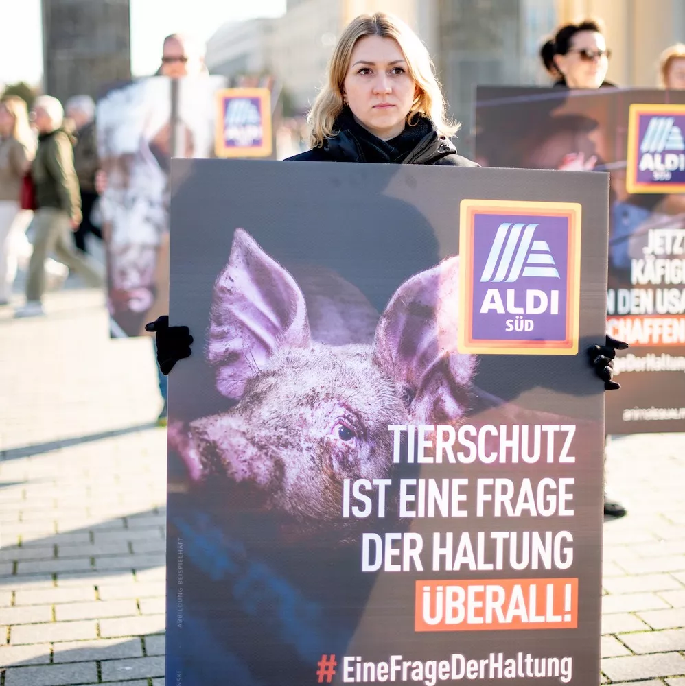 Volunteer with a banner during an Animal Equality protest