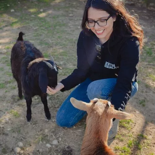 Dulce Ramírez with two goats